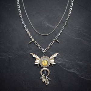 The Wing of Severance bio-mechanical butterfly necklace. Pendant with hand-painted amber eye and crescent moon charm. Archive fashion jewelry.